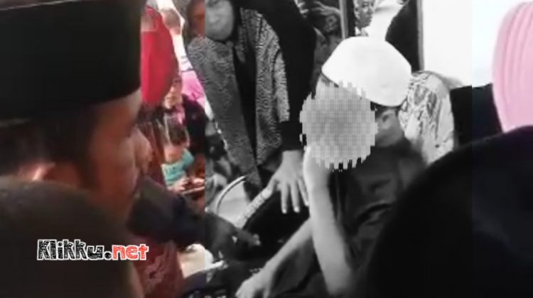 Seorang pemuda berkopiah putih dikerumunin warga, diduga pelaku maling (Photo Screnshoot video warga)